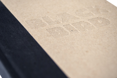 An original option for hardcover books is to leave the cardboard without any covering and emboss it.